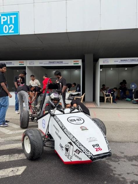 PR26 with driver seated, rolling out of Pit 02