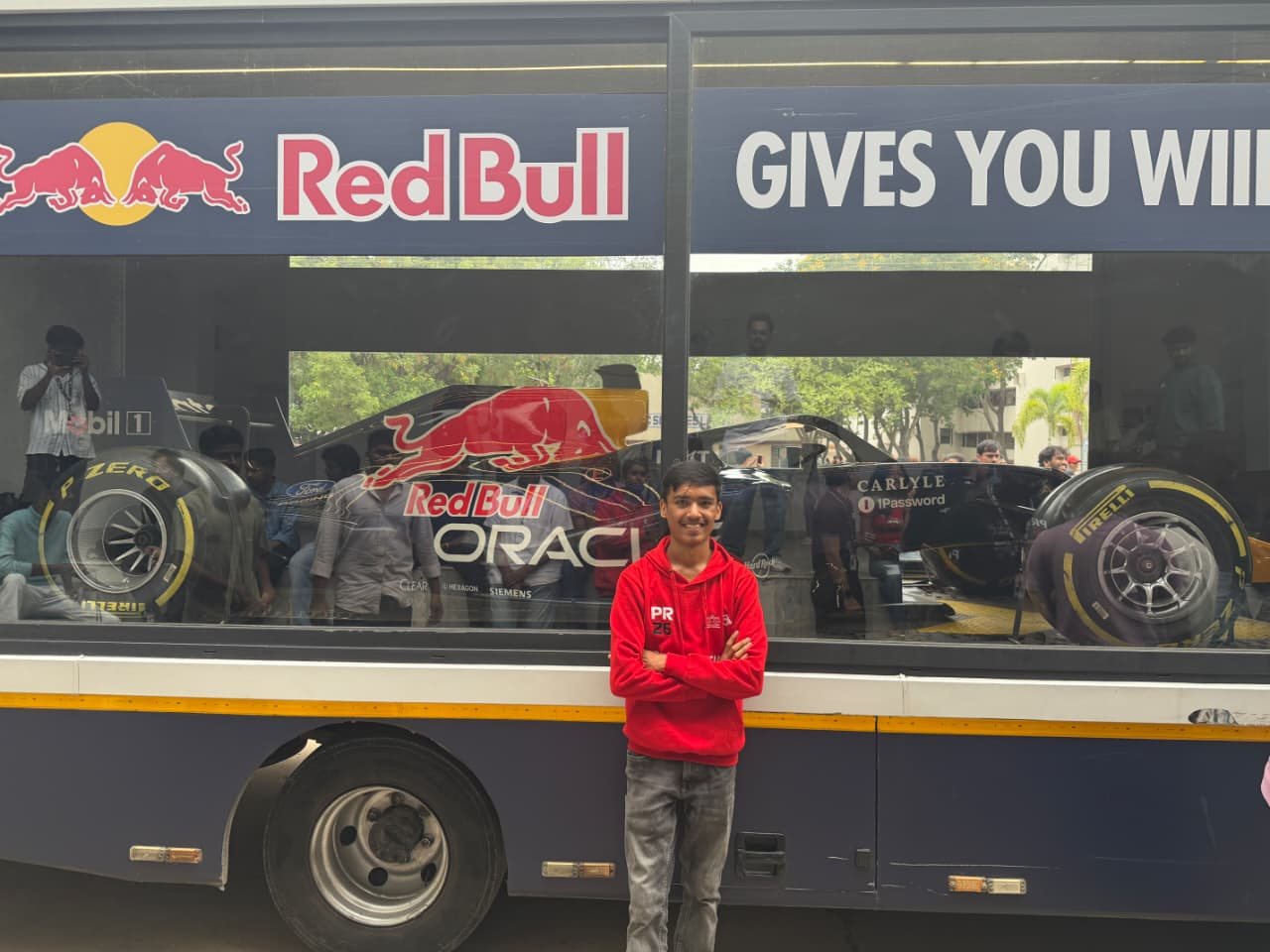 Hardik Sarda in a PR26 hoodie in front of the Red Bull Racing F1 show car