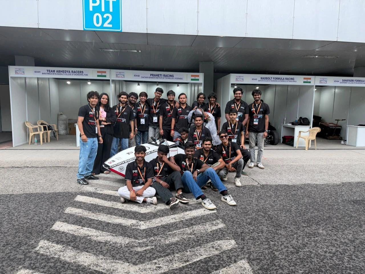 Praheti Racing team posing with PR26 in front of the pit garages